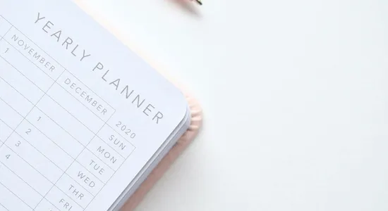 A stylish yearly planner open to a 2020 calendar