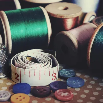 Close-up of vintage sewing essentials including