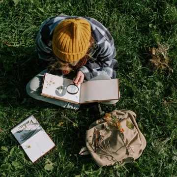 A person explores flora outdoors using a