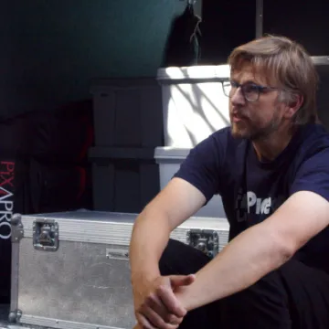 Luke sitting at the back of the OB van