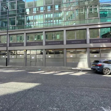 Wide view of spray painting and window panels at Abbey College Manchester.