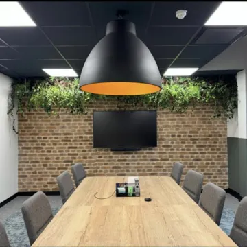 A Manchester office meeting room with a large overhead lamp