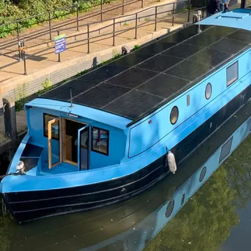 Solar roof panels on blue widebeam river boat