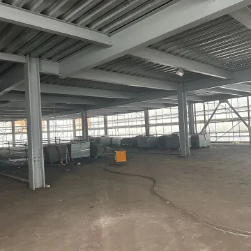 Warehouse interior with large windows and concrete floor
