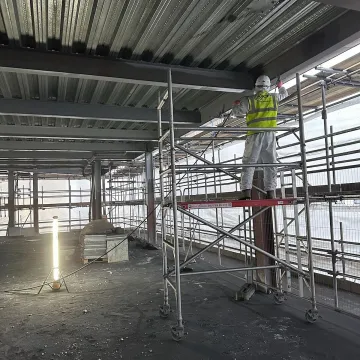 Warehouse construction with staircase and steel frame