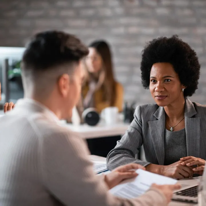 Young couple talking with their financial advisor about thei