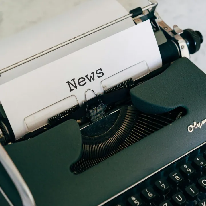 Close-up of an antique typewriter with 'News' on