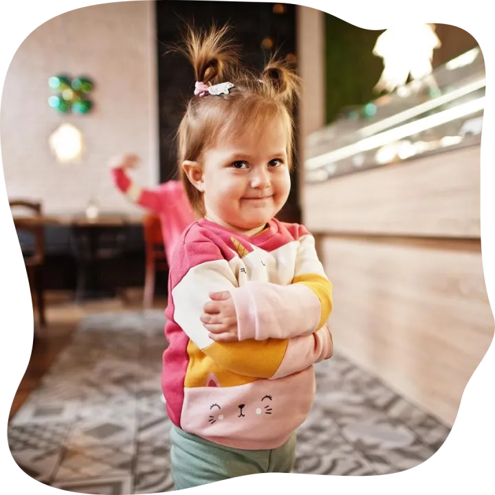Young girl in cafe choose a dessert from shop window