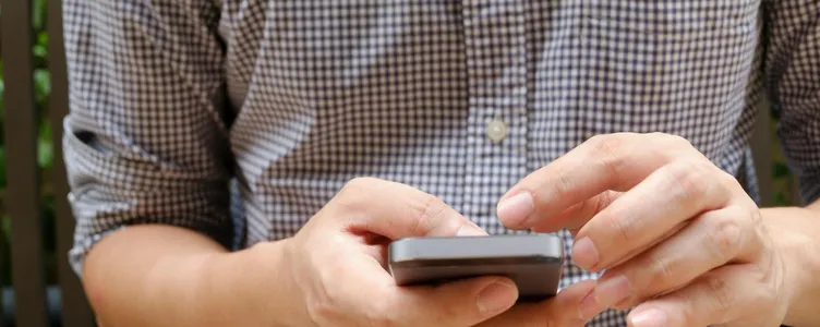 Close-up of a man using a smartphone, focusing on