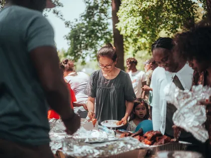 Families sharing food together at an outdoor community gathering
