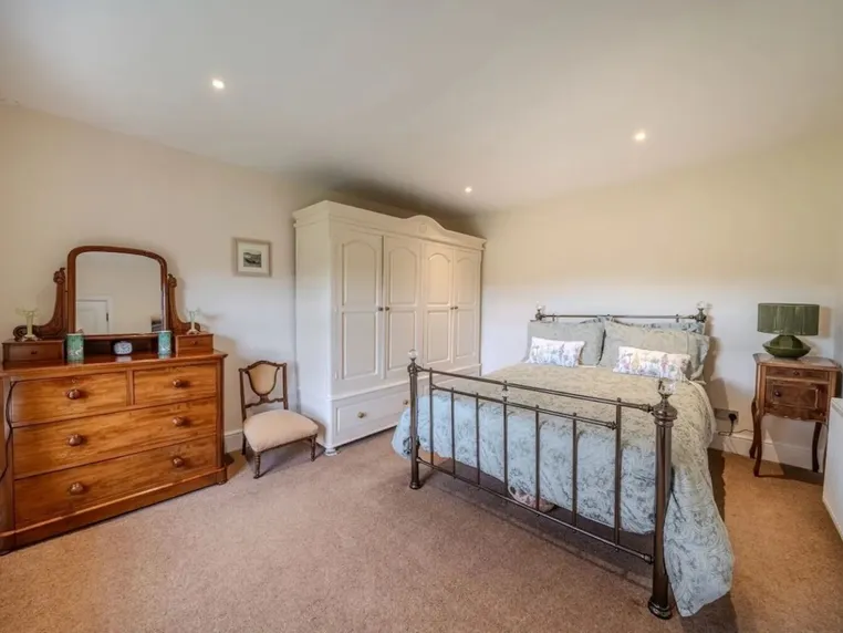 Bedroom two with a king-size bed and countryside views