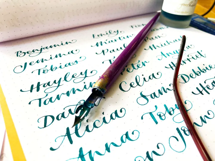 Hand written wedding place cards in blue modern calligraphy