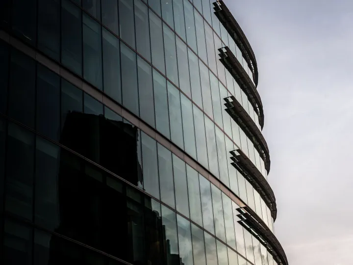 Contemporary glass office building in London reflecting the cityscape