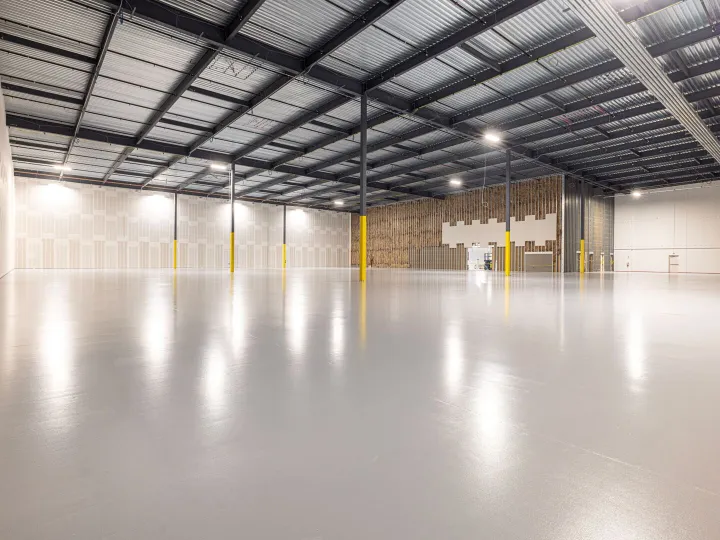 Empty modern warehouse interior with polished concrete floor