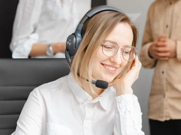 A cheerful woman working at a call center