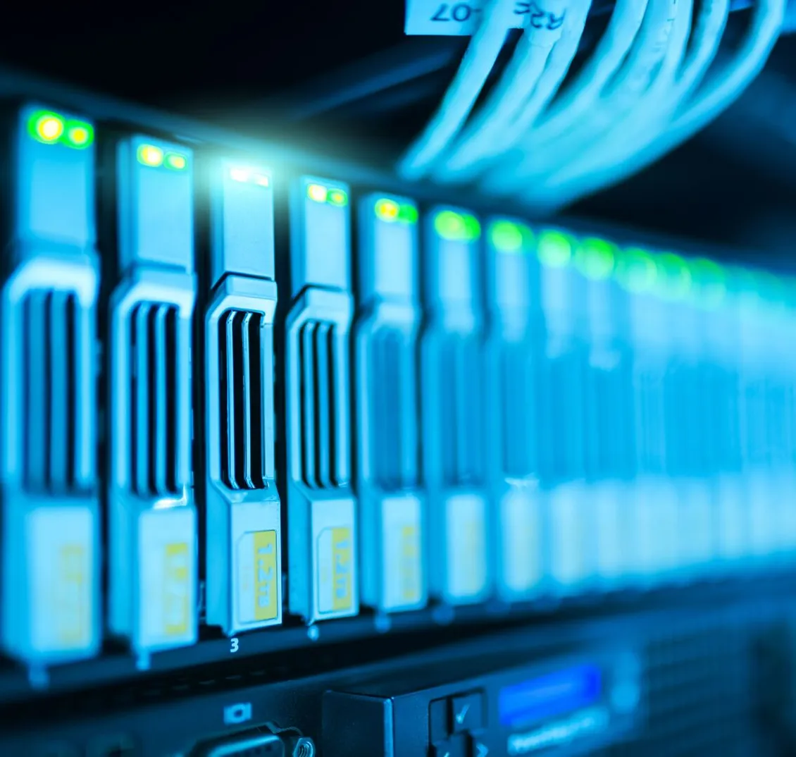 Close-up of a server rack with glowing blue indicator lights