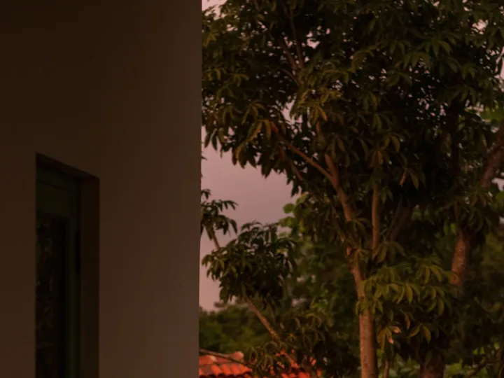 Balcony seating at dusk overlooking the tropical estate at Peacock Hill Sigiriya