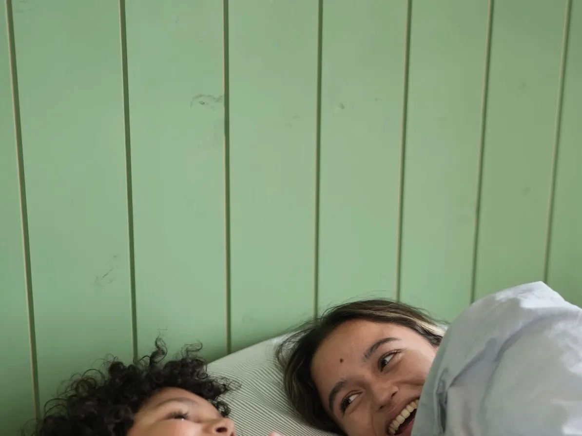 Children waking slowly in a green panelled bedroom at Peacock Hill Sigiriya
