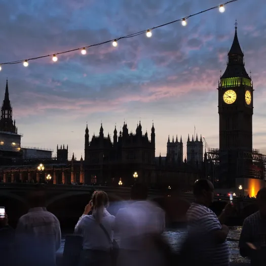 Big Ben lit up against an evening sky