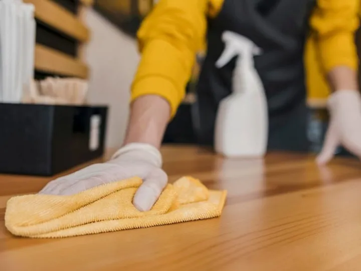 Front view of barista cleaning table
