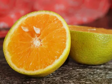 Vibrant close-up of a juicy orange sliced in half