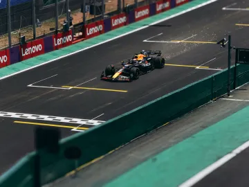 A Formula 1 car speeds down the track during a race, showcasing high performance.