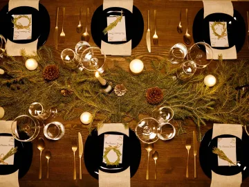 Elegant Christmas dinner table with candles, pine