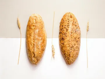 Flat lay image of two artisan bread loaves with wh