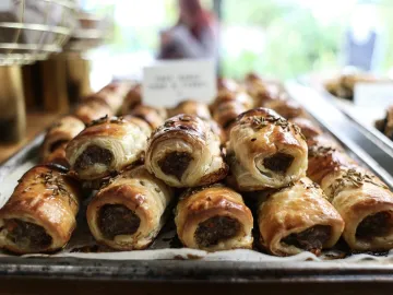 Close-up of freshly baked sausage rolls with
