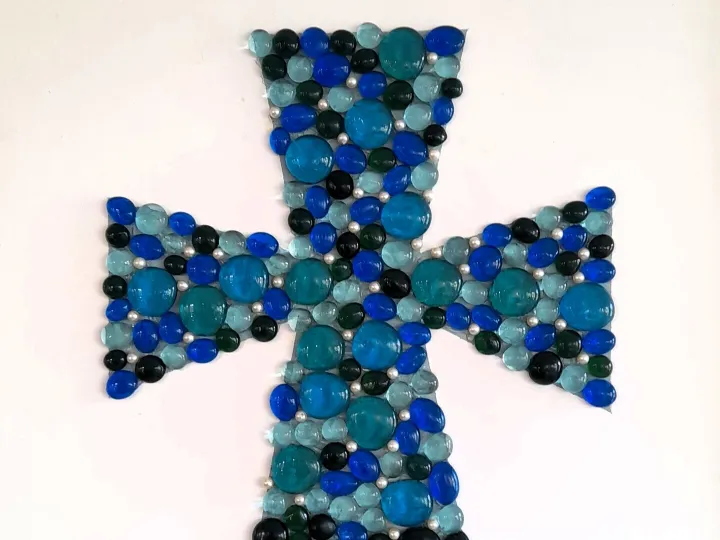 Framed glass cross made by the Friendly Faces group (2025)