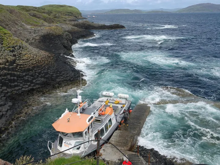 Tourist boat docked at Fingal's Cave, Isle of 
