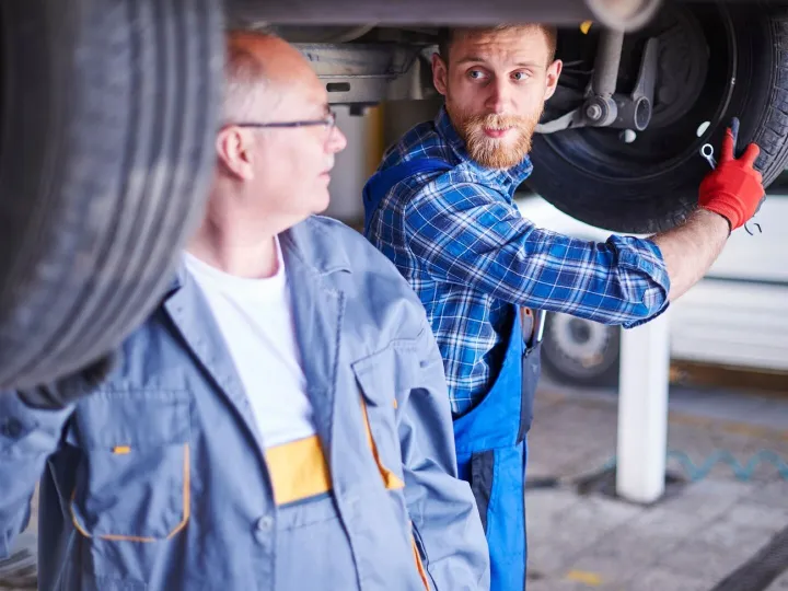 Mechanics repairing a car in the workshop