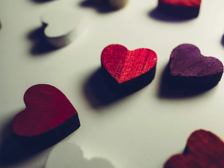 Vibrant wooden heart shapes in red and purple