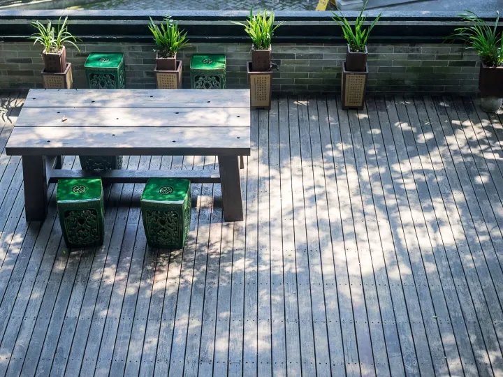 Terrace with a wooden table and plants
