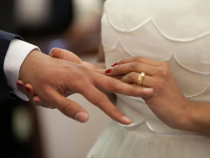 Close-up of a bride and groom exchanging rings